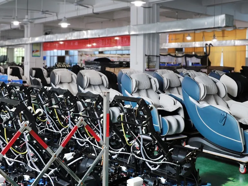 Finished massage chairs arranged in rows for storage before shipment.