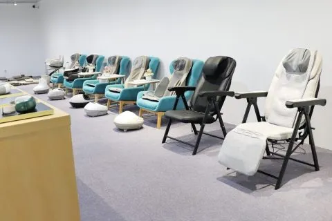 Massage chairs displayed in a showroom with different models arranged for viewing.