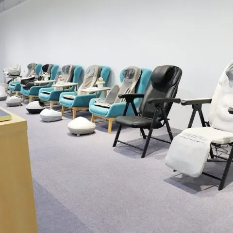 Massage chairs displayed in a showroom with different models arranged for viewing.