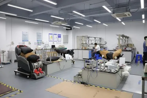 Massage chairs connected to test benches and instruments in the Forrest product testing laboratory.