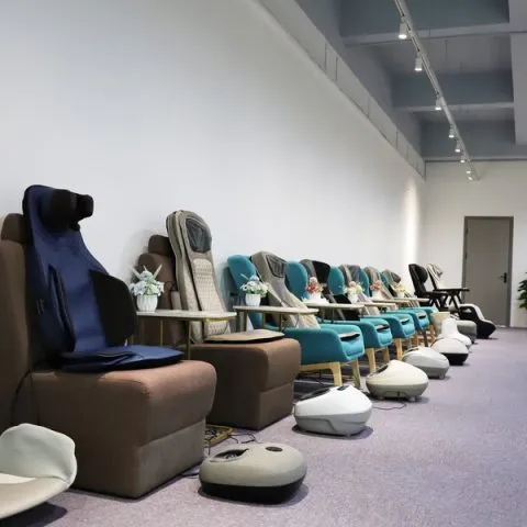 Relaxation and massage products displayed along the wall of a modern showroom.