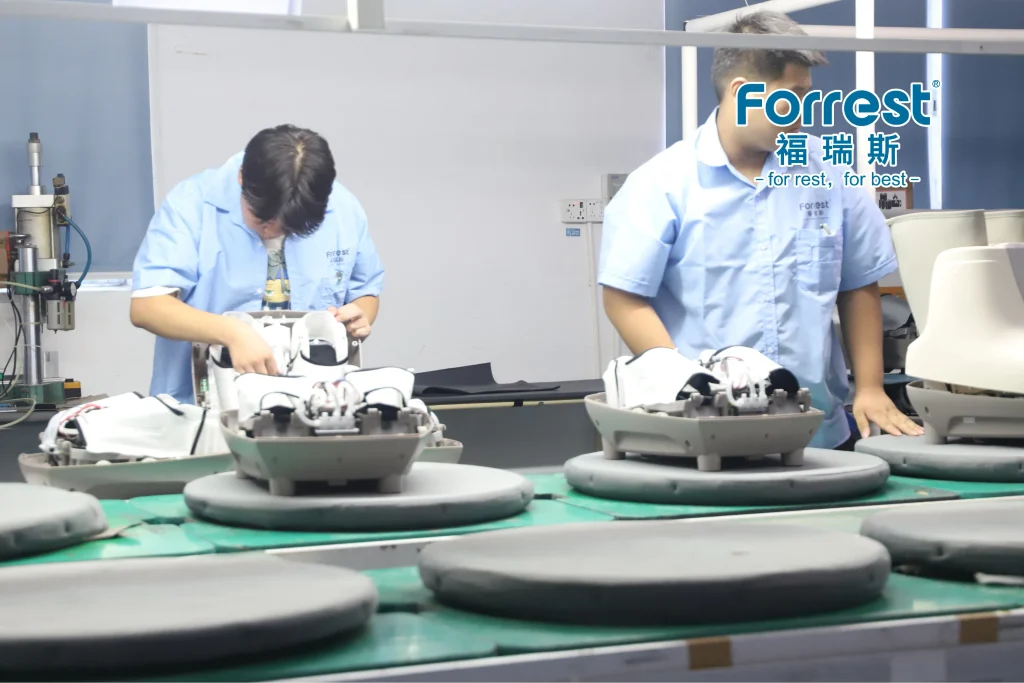 Factory worker assembling internal components of a custom foot massager