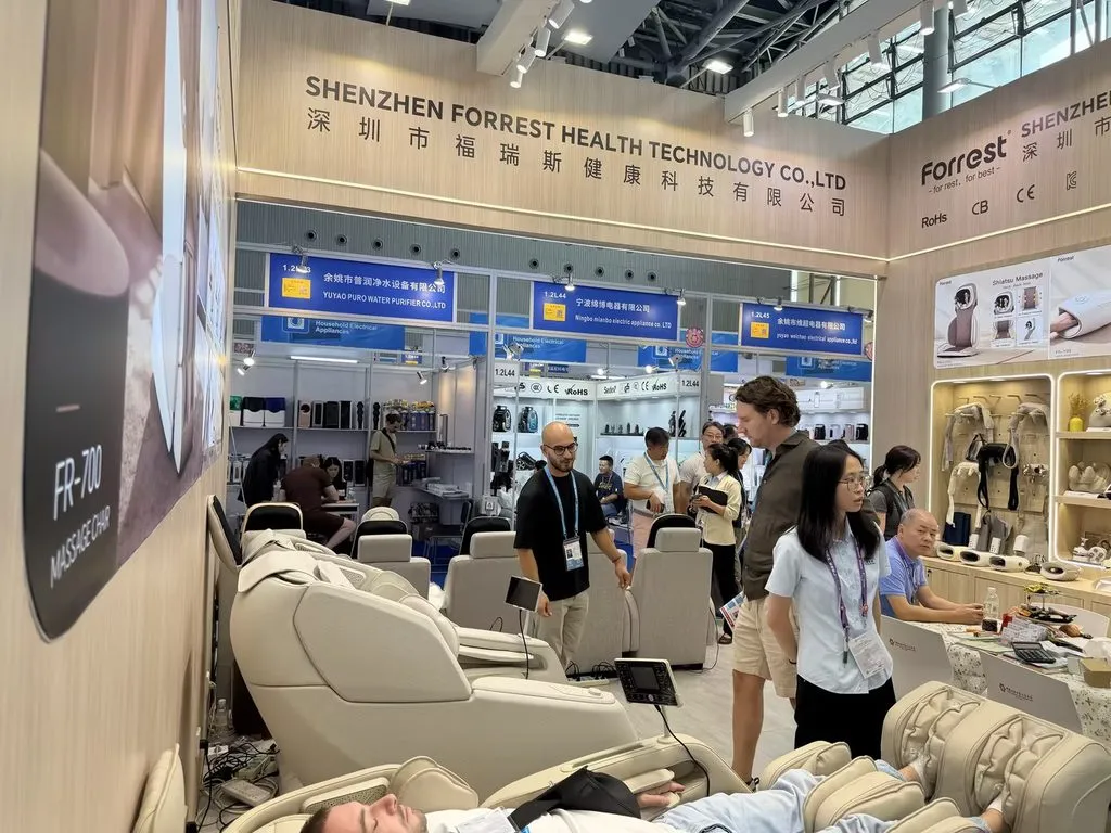 Hands-on experience at the Forrest booth — buyers testing our latest massage chairs.